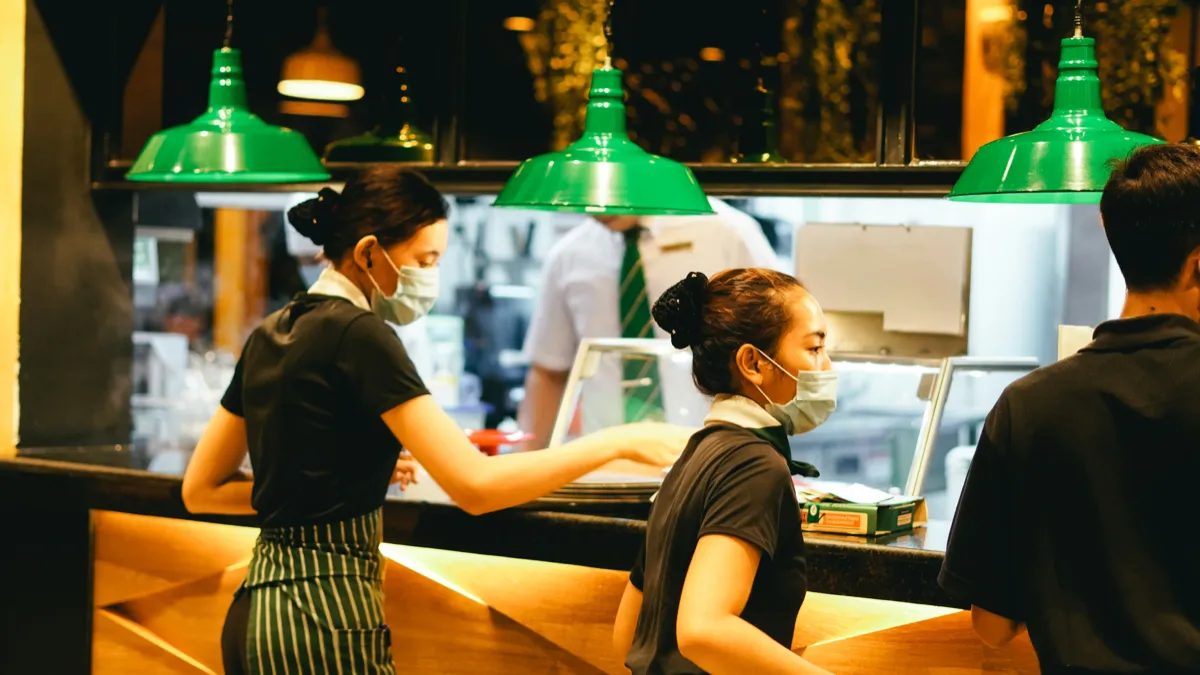 Chef preparing food in a busy commercial kitchen